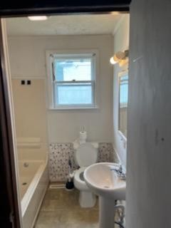 231 Gay Street Erwin, TN 37650 - Photo 7 of 7 a bathroom with a toilet a sink and bathtub