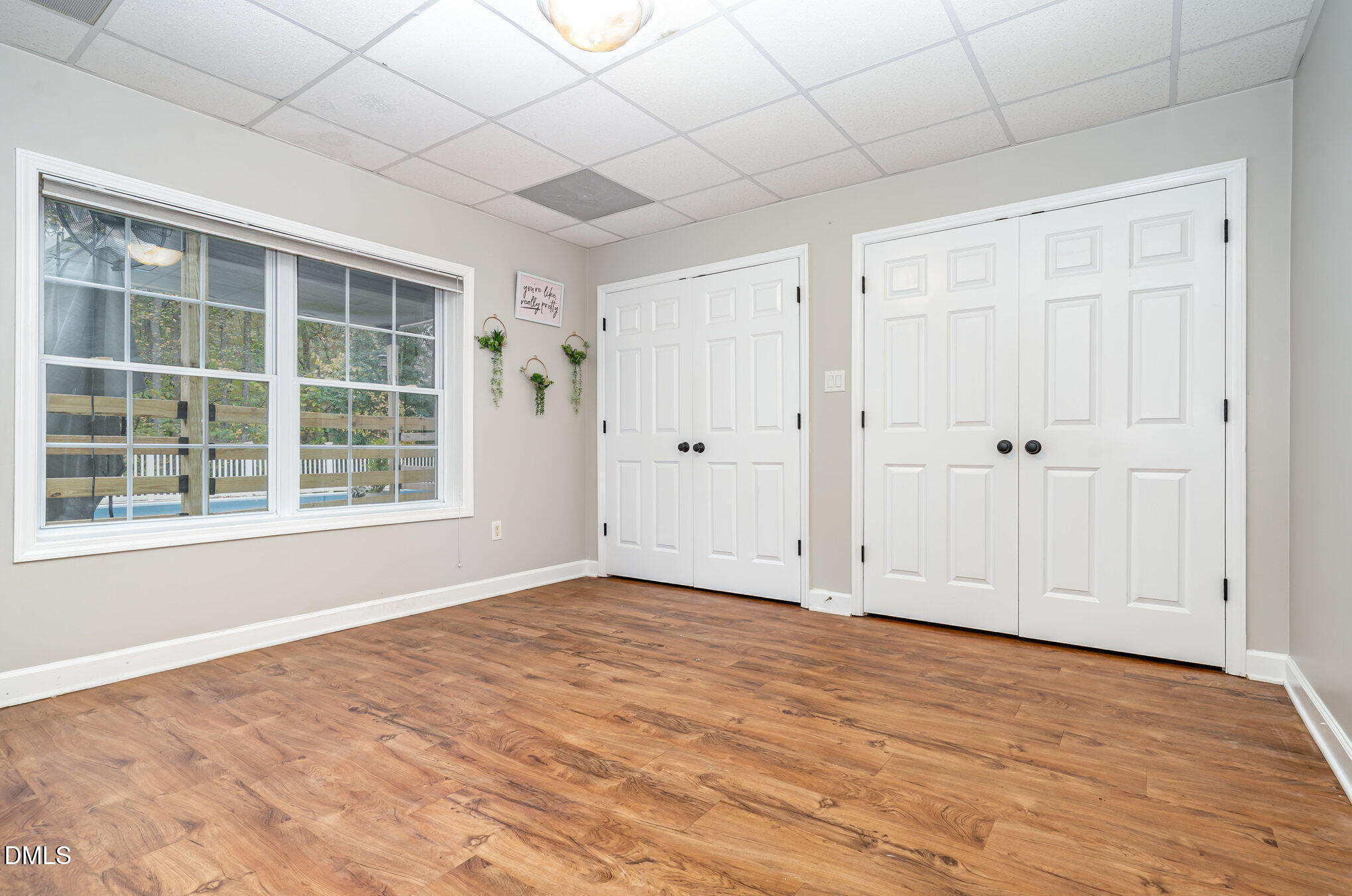 9036 Sundance Street Wake Forest, NC 27587 - Photo 11 of 22 an empty room with wooden floor and windows