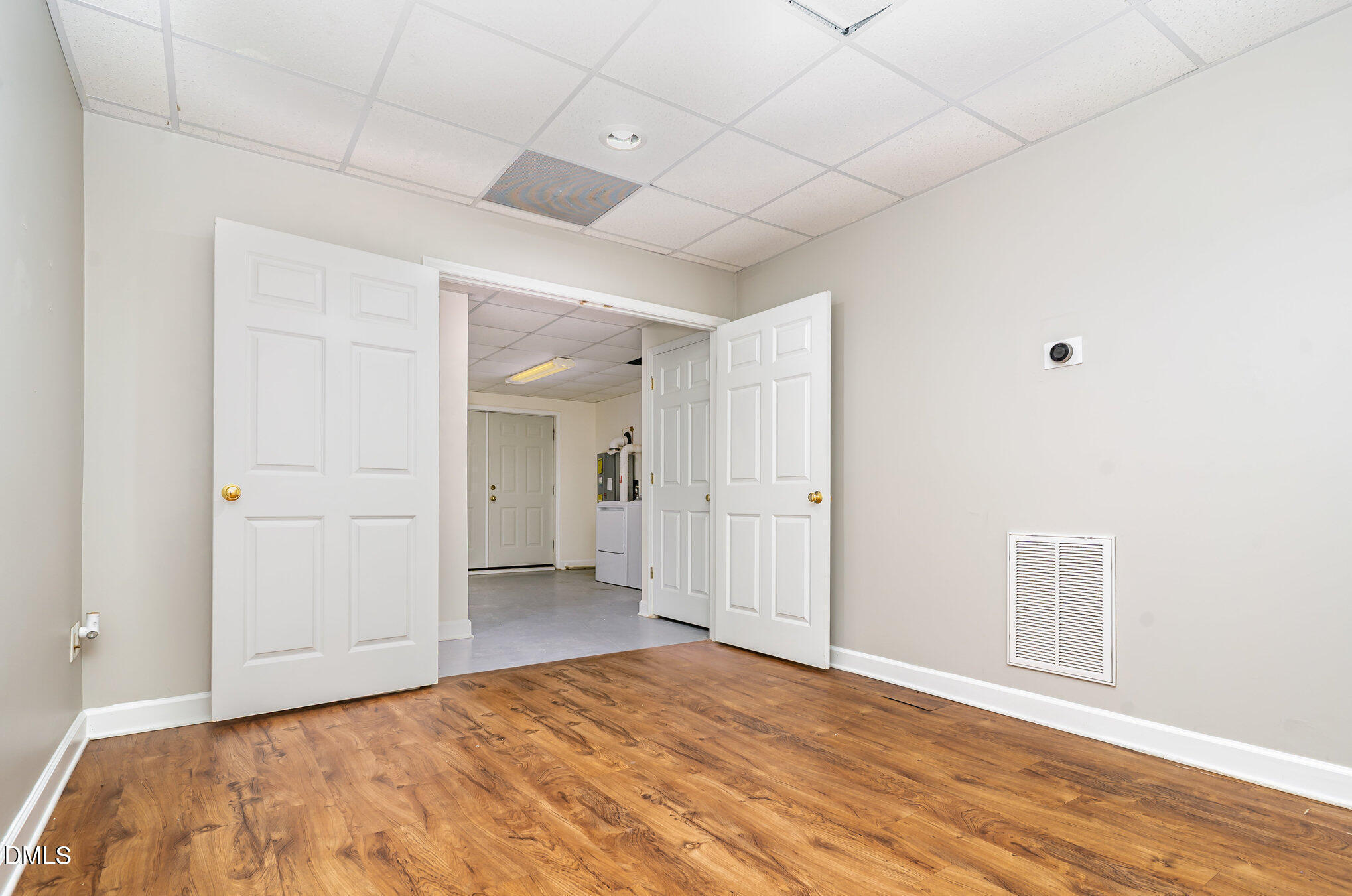 9036 Sundance Street Wake Forest, NC 27587 - Photo 15 of 22 a view of an empty room with wooden floor