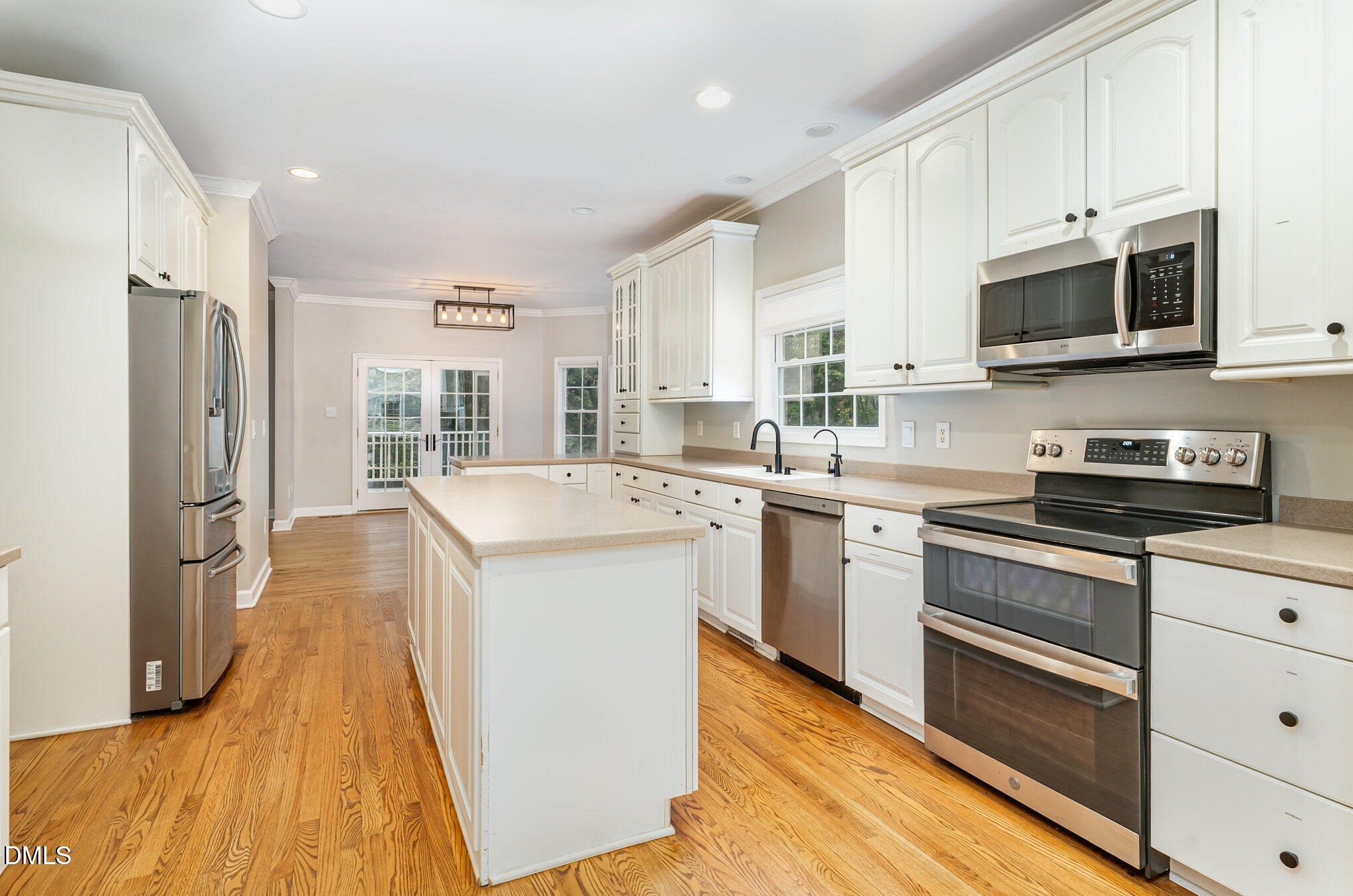 9036 Sundance Street Wake Forest, NC 27587 - Photo 2 of 22 a kitchen with stainless steel appliances a stove sink microwave and cabinets