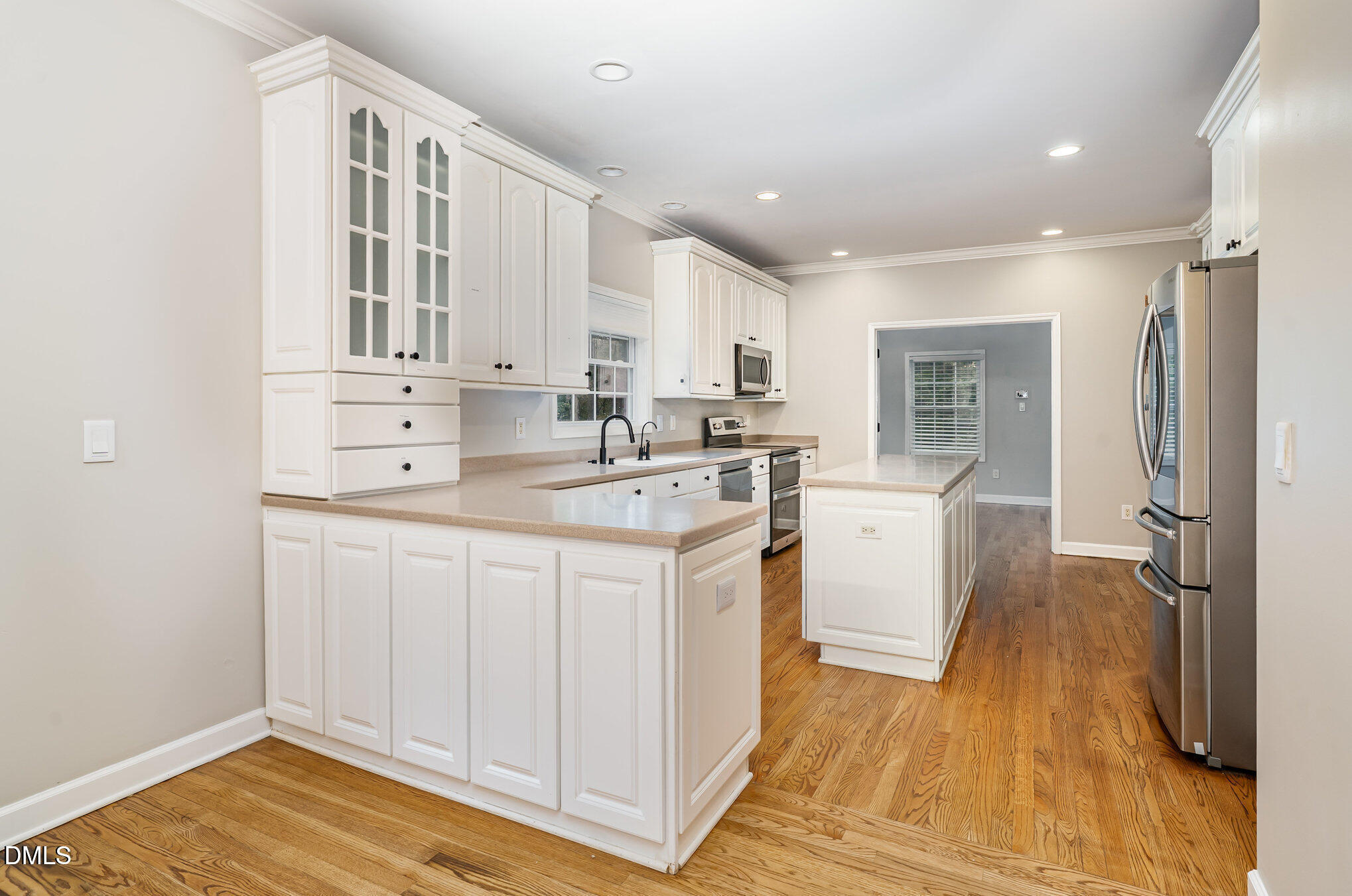 9036 Sundance Street Wake Forest, NC 27587 - Photo 3 of 22 a kitchen with white cabinets and sink