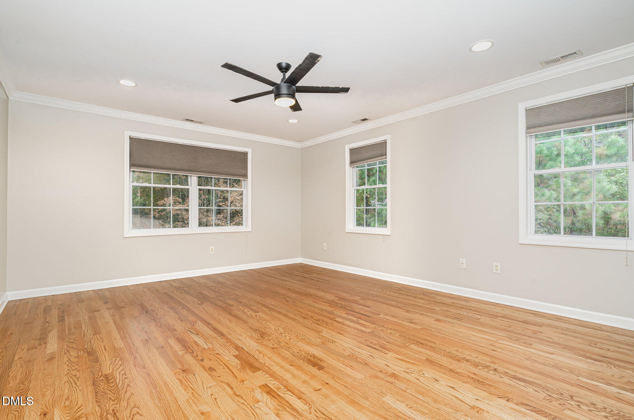 9036 Sundance Street Wake Forest, NC 27587 - Photo 6 of 22 a view of empty room with wooden floor and fan