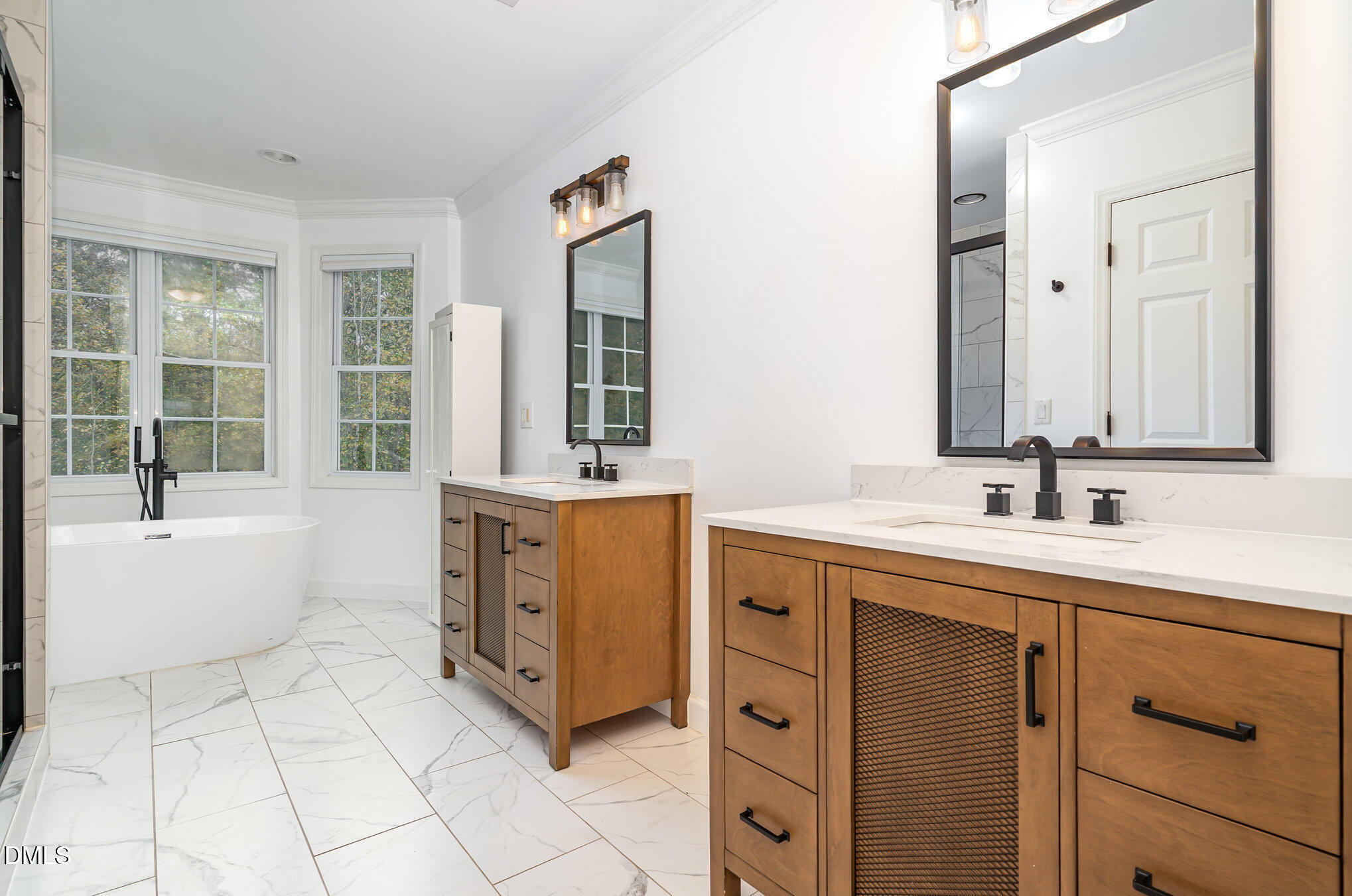 9036 Sundance Street Wake Forest, NC 27587 - Photo 9 of 22 a spacious bathroom with a double vanity sink a mirror and a bathtub