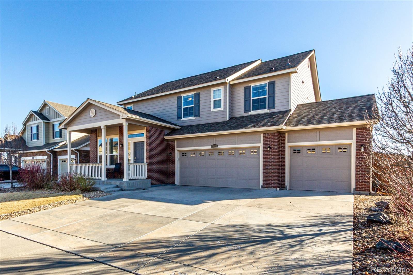 21074 East Doane Place Aurora, CO 80013 - Photo 3 of 44 a front view of a house with a yard and garage