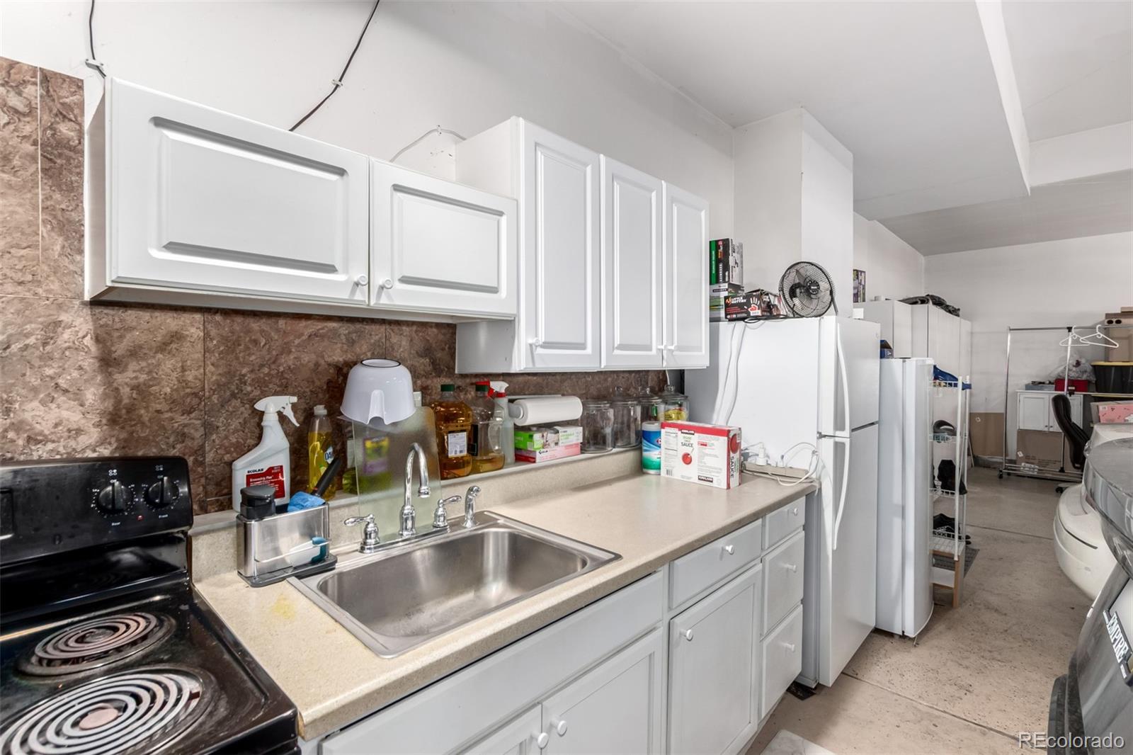 21074 East Doane Place Aurora, CO 80013 - Photo 44 of 44 a kitchen with refrigerator and cabinets