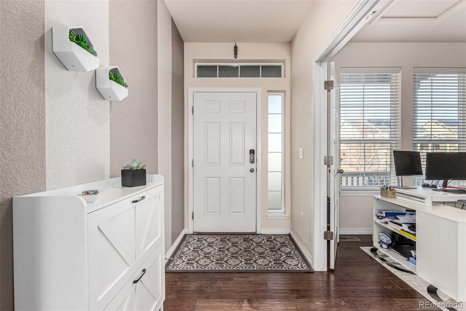 21074 East Doane Place Aurora, CO 80013 - Photo 5 of 44 a room with a rug and white walls