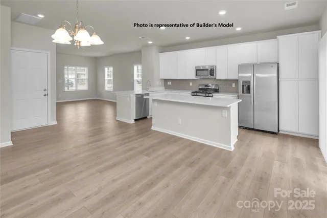 a kitchen with a refrigerator sink and cabinets