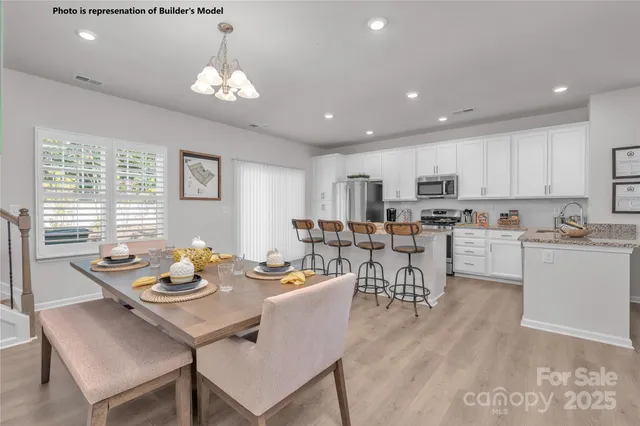 a view of a dining room with furniture and chandelier