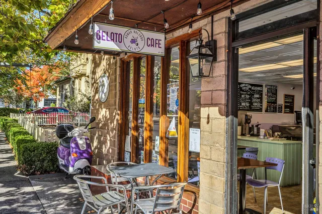 a view of a patio with table and chairs under an umbrella