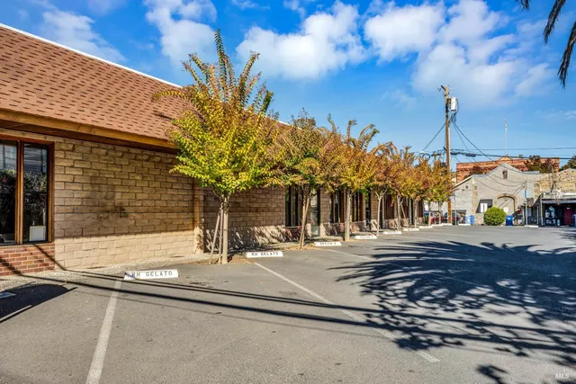 a view of a building with a tree in front