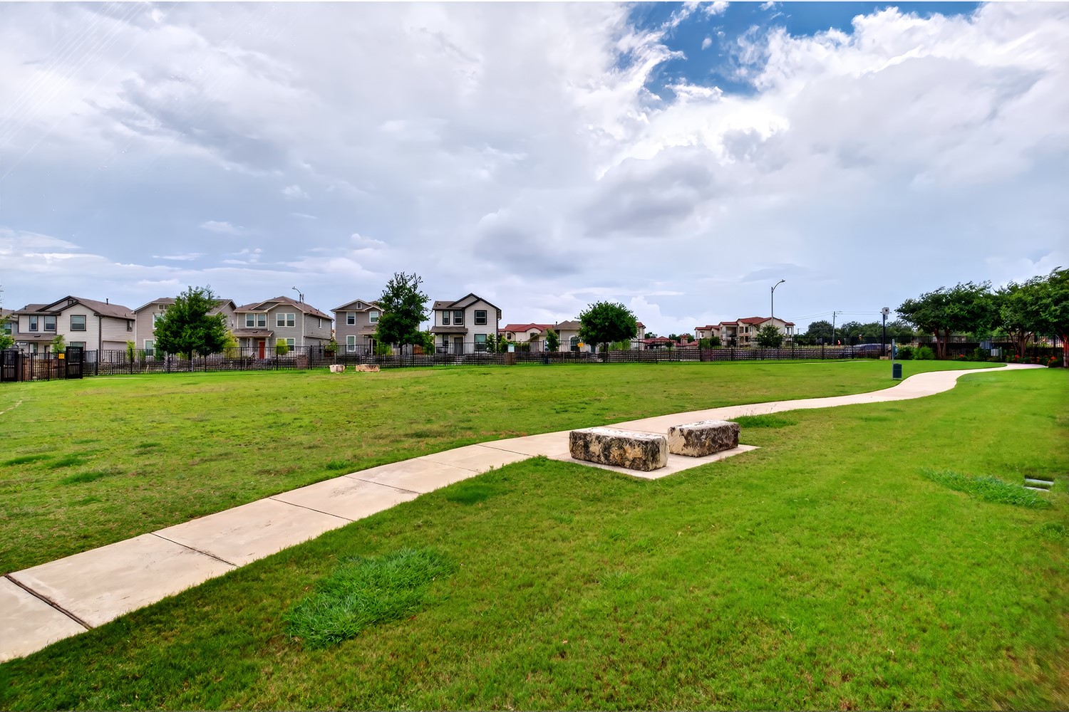 2006 Grow Lane Austin, TX 78754 - Photo 39 of 40 Green space with paved walking paths offers a serene neighborhood setting.