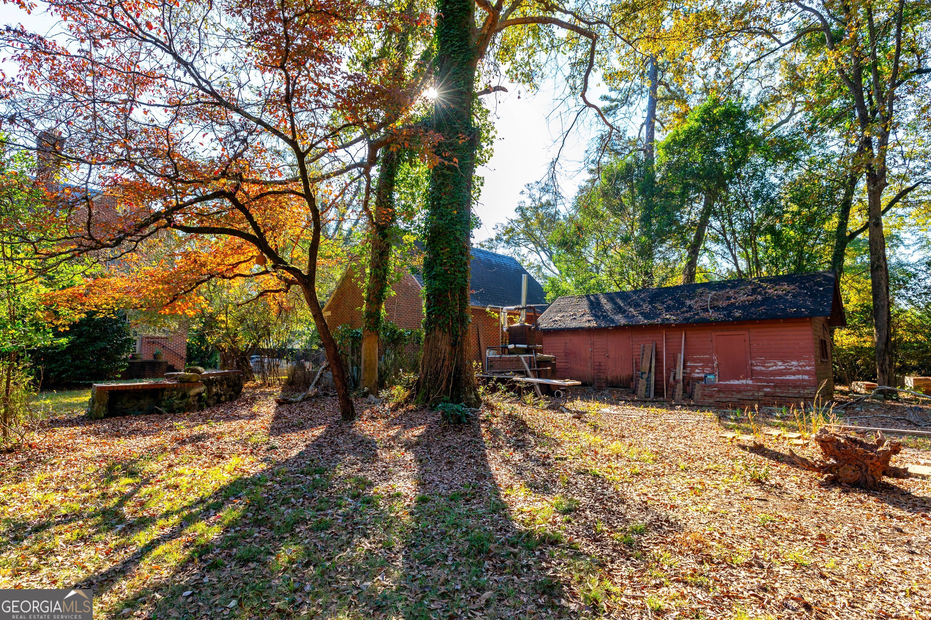 300 Poplar Drive Thomaston, GA 30286 - Photo 13 of 19 a view of a backyard with a table and chairs and a large tree