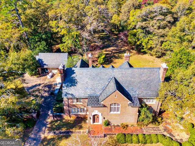 an aerial view of a house with yard swimming pool and outdoor seating
