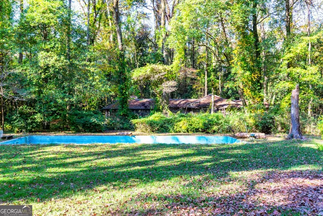 a big house with large trees and brick walls
