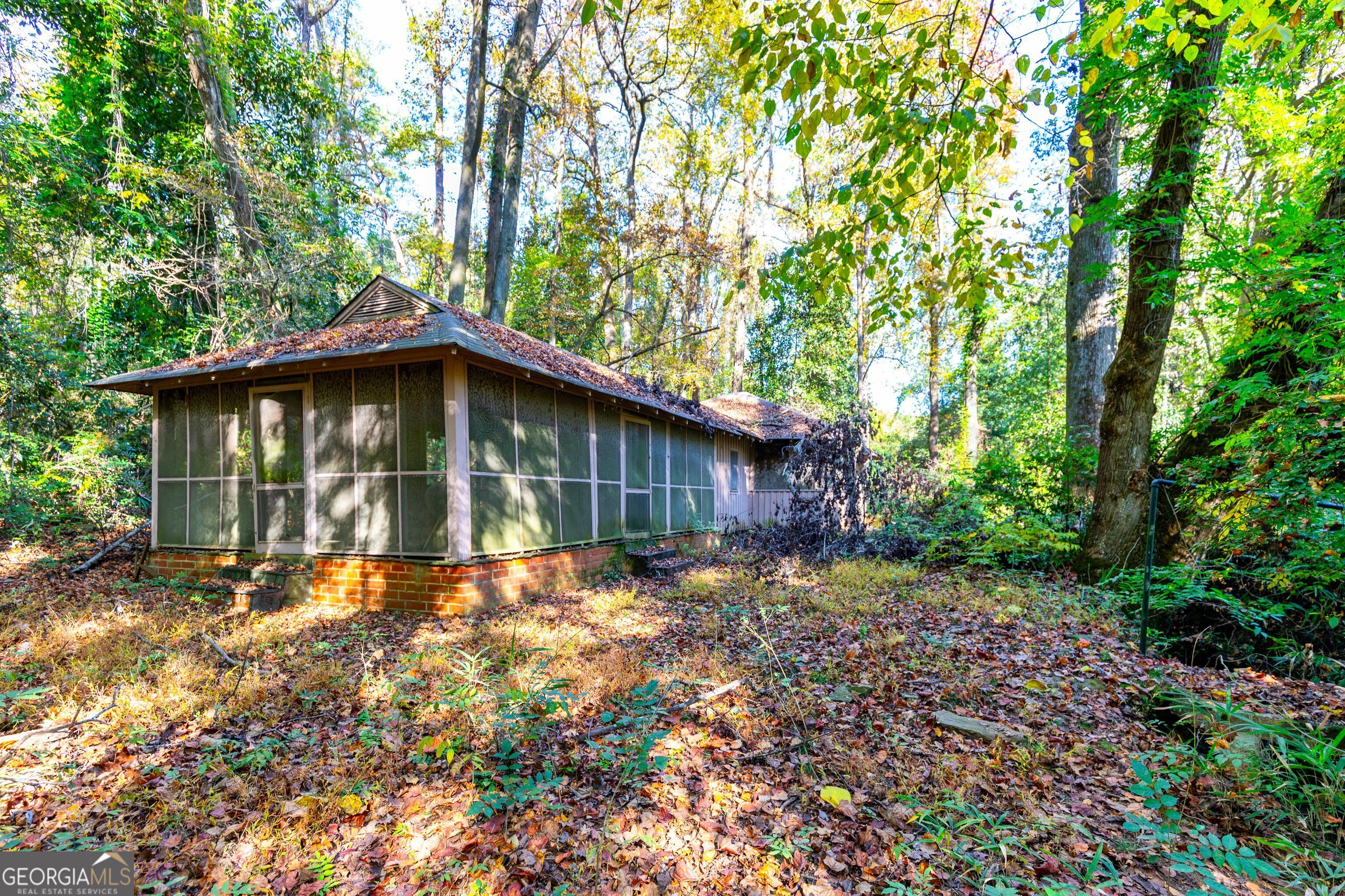 300 Poplar Drive Thomaston, GA 30286 - Photo 8 of 19 a big house with large trees and brick walls