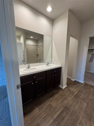 a bathroom with a double vanity sink and mirror