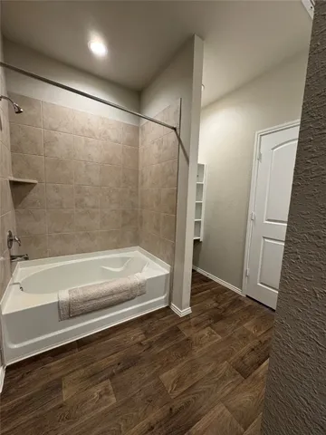 a bathroom with a bathtub and a shower