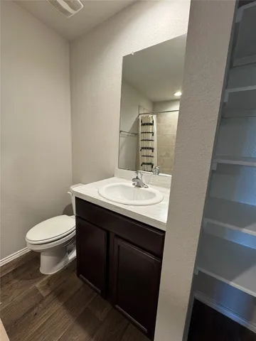 a bathroom with a sink toilet and a mirror
