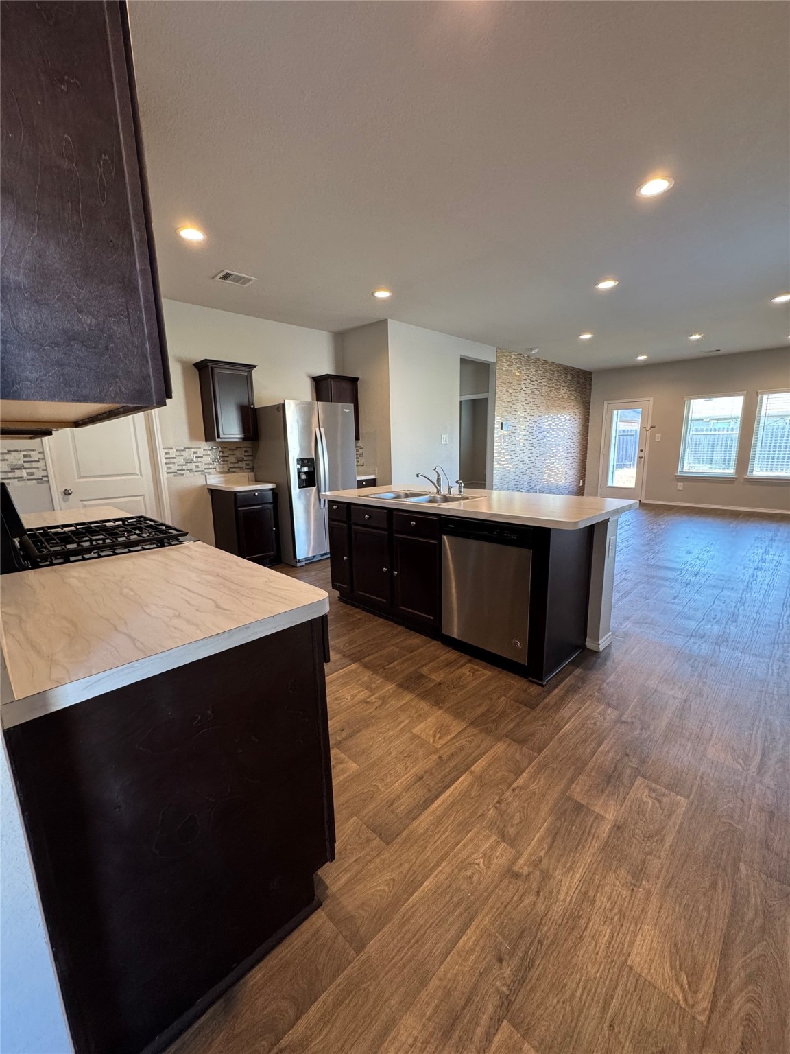2419 Norwood Stand Trail Spring Spring, TX 77373 - Photo 5 of 21 a large kitchen with kitchen island a sink dishwasher a stove and a refrigerator with wooden floor