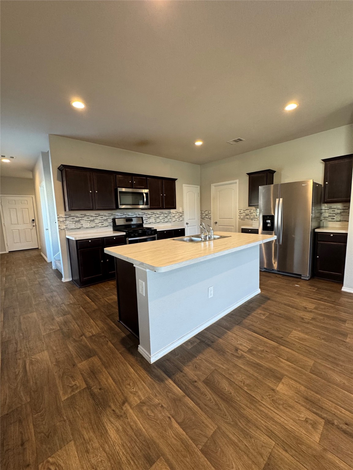 2419 Norwood Stand Trail Spring Spring, TX 77373 - Photo 7 of 21 a large kitchen with stainless steel appliances granite countertop a stove a sink dishwasher and a microwave oven on the wooden floor