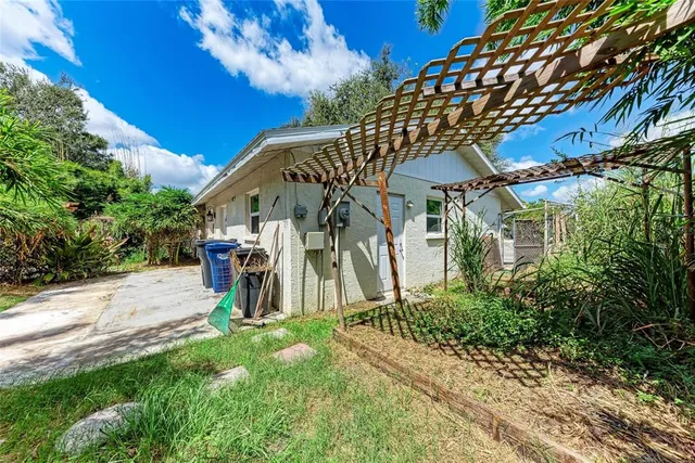a view of a house with backyard and a tree