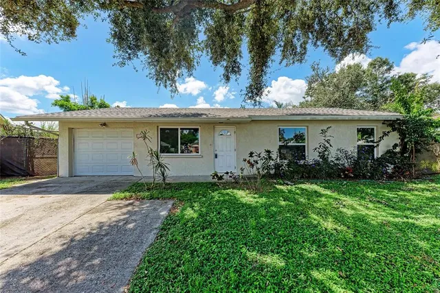 a front view of a house with a yard and a garage
