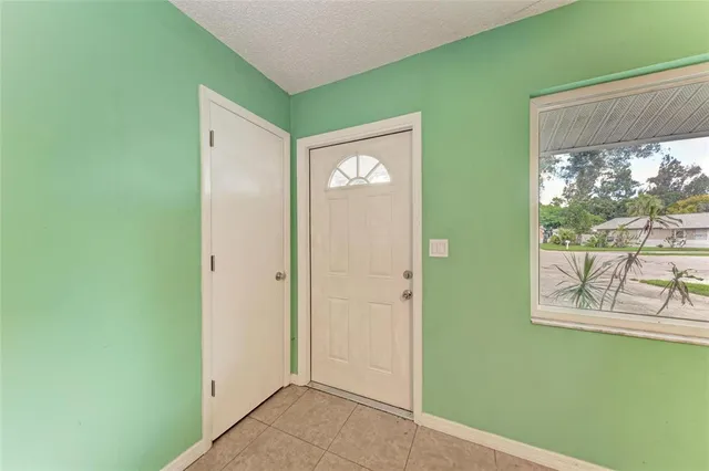 a view of an empty room with a kitchen