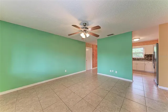 an empty room with closet and a ceiling fan