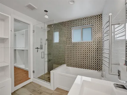 a bathroom with a bathtub and shower