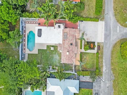 a aerial view of a house with garden space and street view