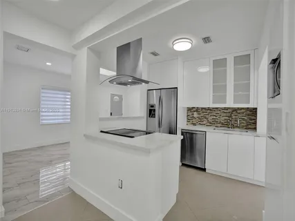 a kitchen with a stove and a refrigerator