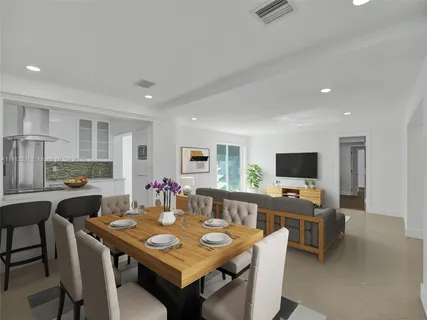 a view of a dining room with furniture and a flat screen tv