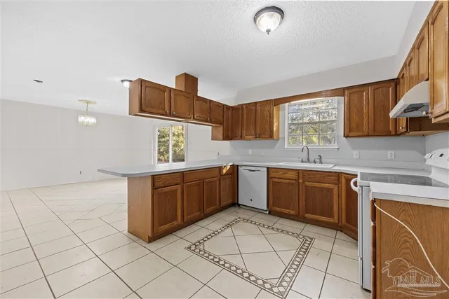 a kitchen with a sink cabinets and window