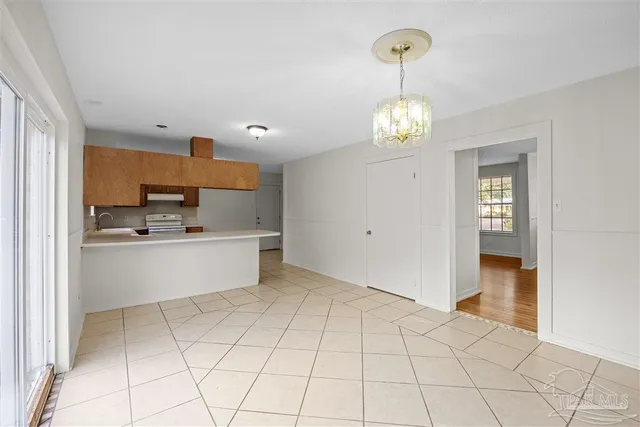 a view of kitchen with granite countertop cabinets and window