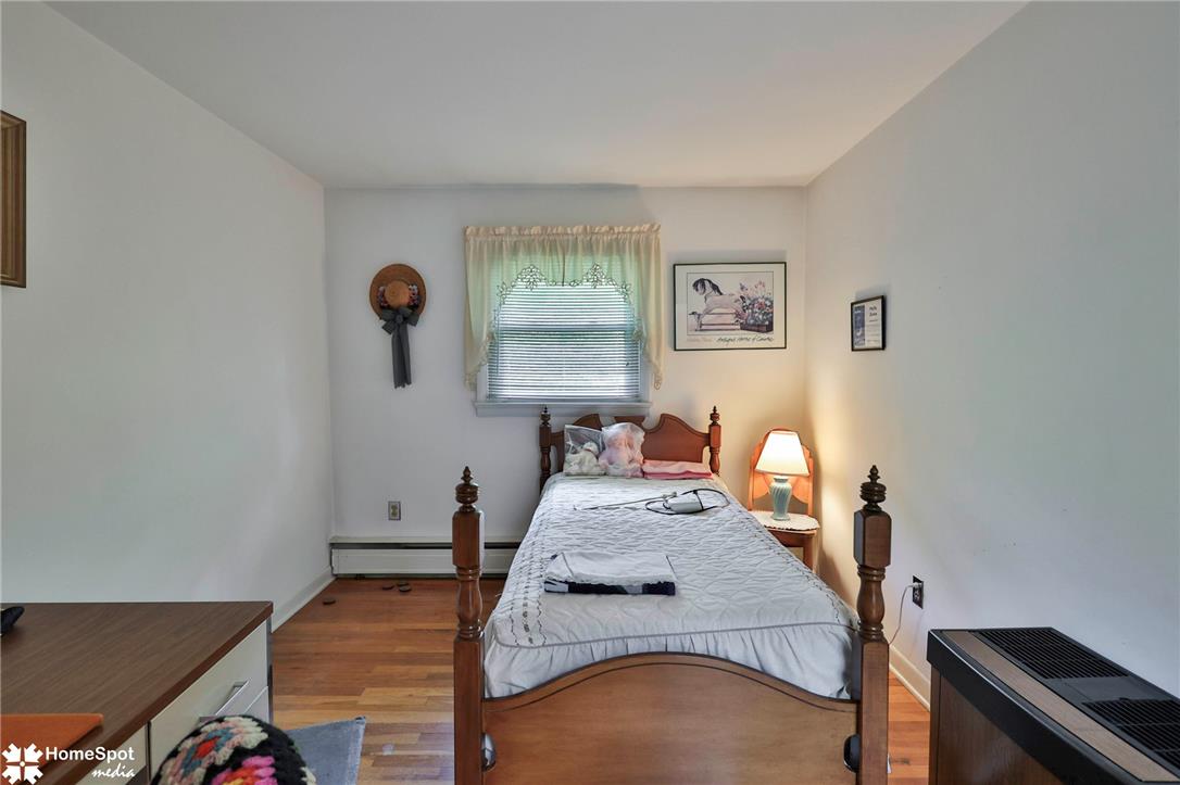 6054 Old Hickory Road Coopersburg, PA 18036 - Photo 22 of 48 Warm hardwood floors anchor this inviting bedroom illuminated by natural light from a central window.