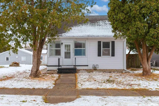a view of a house with snow on the background
