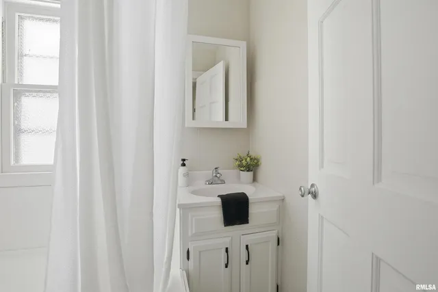 a bathroom with a sink and mirror