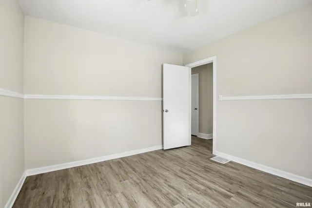 an empty room with wooden floor