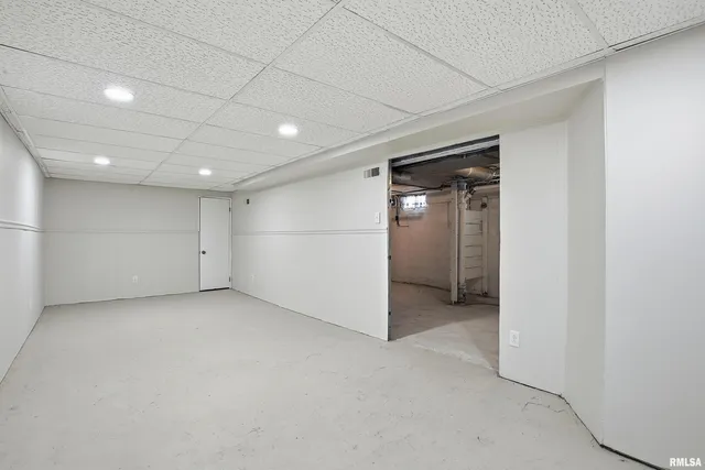 an empty room with closet and windows