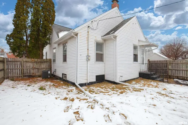 a view of a house with a yard covered with snow