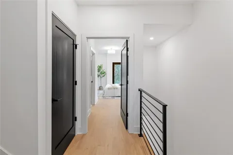 a bedroom with a large bed and a potted plant