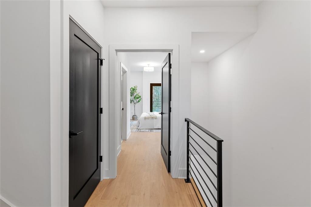 1165 Penny Lane Atlanta, GA 30329 - Photo 17 of 40 a view of a hallway with wooden floor and a bathroom
