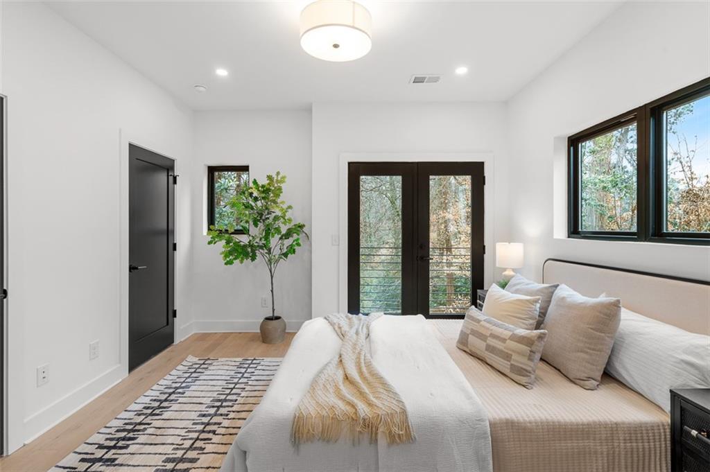 1165 Penny Lane Atlanta, GA 30329 - Photo 19 of 40 a bedroom with a large bed and a potted plant