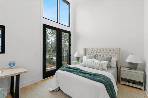 a bedroom with a bed and large window