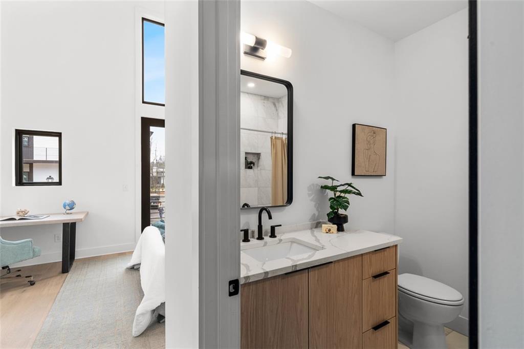 1165 Penny Lane Atlanta, GA 30329 - Photo 28 of 40 a bathroom with a sink a toilet and mirror