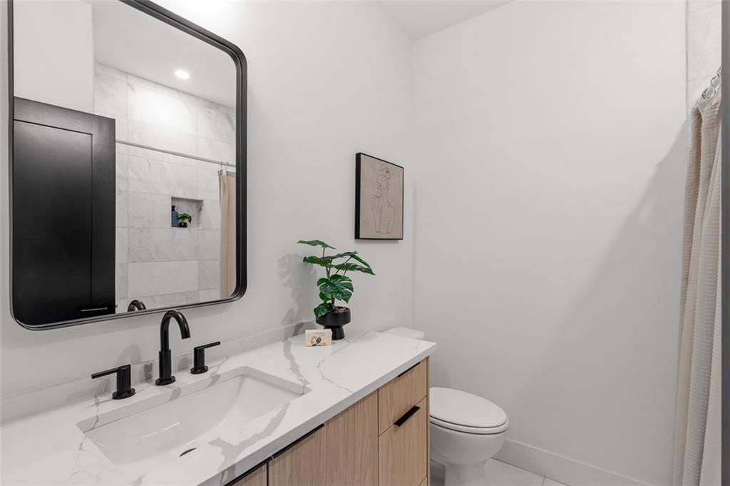 1165 Penny Lane Atlanta, GA 30329 - Photo 29 of 40 a bathroom with a granite countertop sink and a mirror