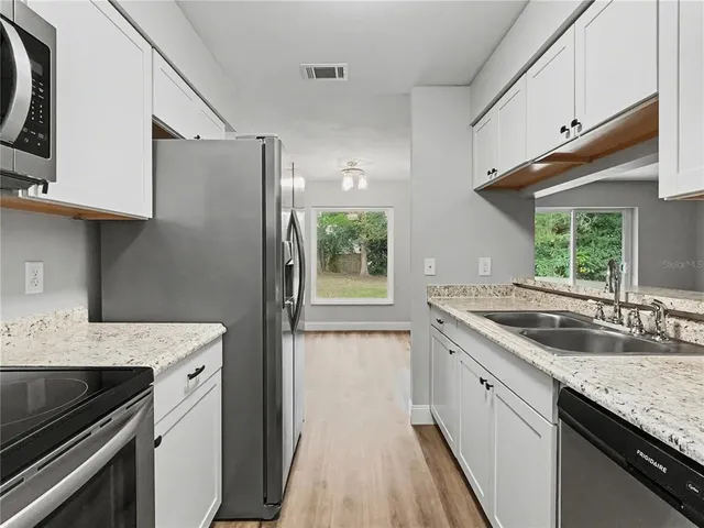 a kitchen with a sink stove and refrigerator