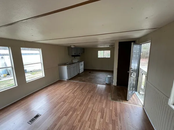wooden floor in an empty room with a window