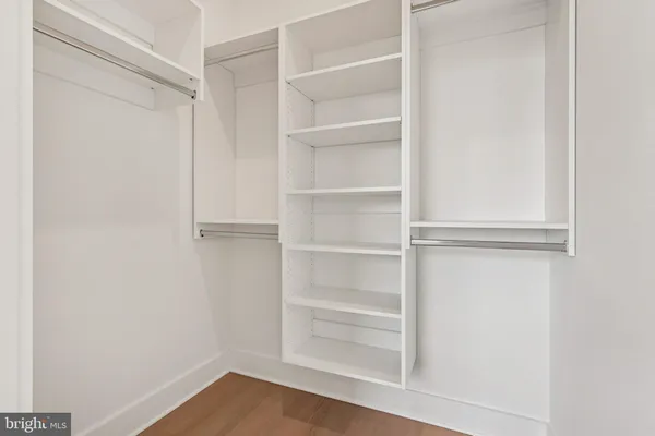 a view of walk in closet with empty racks