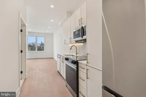 a kitchen with stainless steel appliances granite countertop a stove and a refrigerator